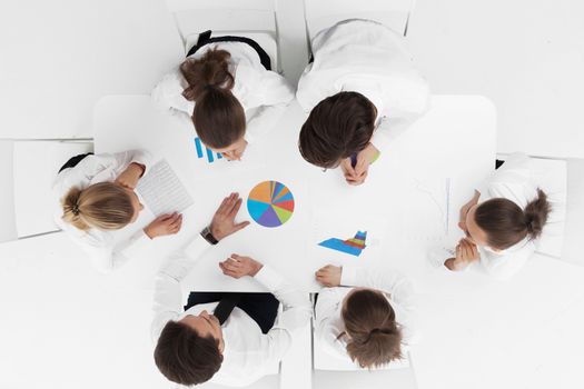 Top view of business people working with financial reports