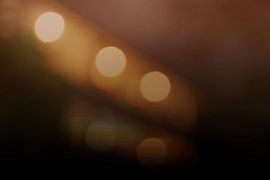 Light orange bokeh background and black coffee.
