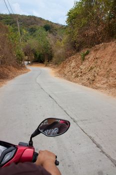 Driving a motorcycle down the mountain.