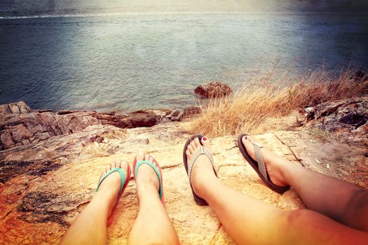 Two people stand on a cliff overlooking Koh Samet Rayong, Thailand. vintage style.