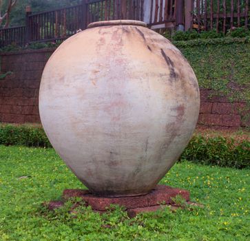 A large brown pottery sphere. Situated in front of the resort in a contemporary style, Thailand.