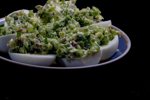 salad with egg and mayonnaise on a plate with a blue border