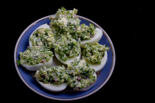 salad with egg and mayonnaise on a plate with a blue border