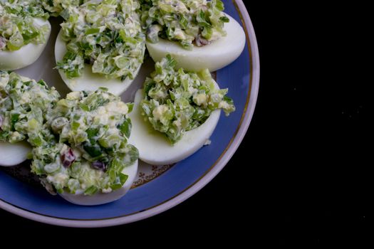 salad with egg and mayonnaise on a plate with a blue border