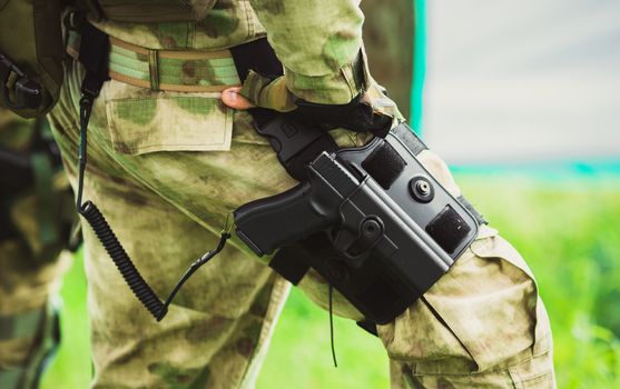 Military man with a gun on his leg