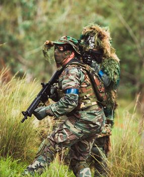 mens in military uniform with weapon on a mission