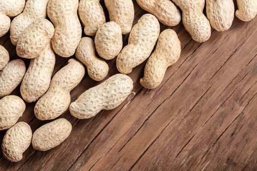 groundnut in the skin close-up on a wooden background