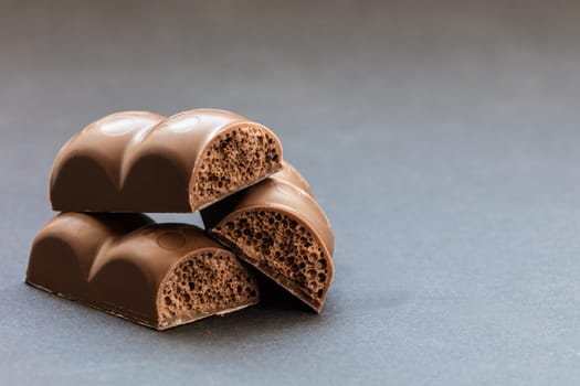 part porous chocolate close-up on a dark background