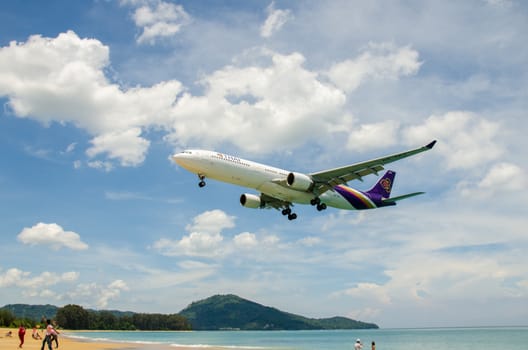 PHUKET - MAY 5 : Thai Airways airplane landing at Phuket International airport, runway near the beach, on May 5, 2016 Phuket, Thailand.