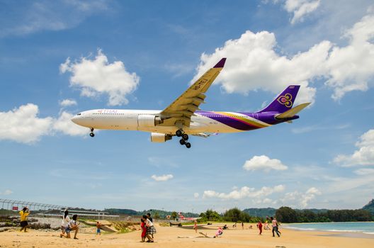 PHUKET - MAY 5 : Thai Airways airplane landing at Phuket International airport, runway near the beach, on May 5, 2016 Phuket, Thailand.