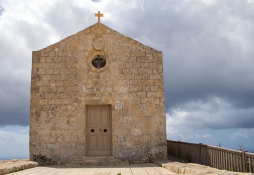 St. Mary Magdalene Chapel was rebuilt on the cliff edge in the seventeenth century. Located in Dingli at the mediterranean island Malta. Intense clouds.