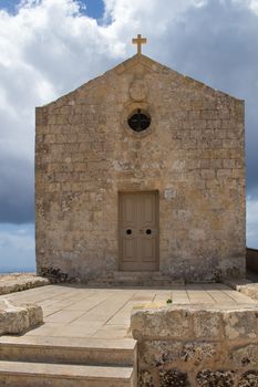 St. Mary Magdalene Chapel was rebuilt on the cliff edge in the seventeenth century. Located in Dingli at the mediterranean island Malta. Intense clouds.