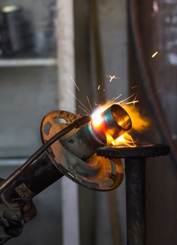 Welders were repairing cutting Shock absorbers of a car in workshop