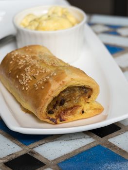 Close up of sausage roll in white plate