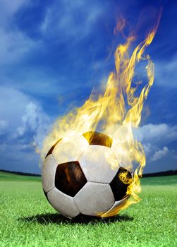 fiery soccer ball on green field