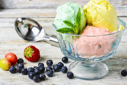 bowl of ice cream,spoon for ice cream and berries