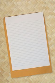 Blank Line paper with Envelope over Bamboo Weaving Background