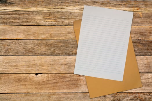 Blank Note Paper with Brown Envelope over Wood Blackground