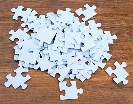 Pile of puzzle pieces on table, top view