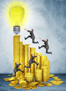 Businessmen run and jump on money stairs to light bulb on top