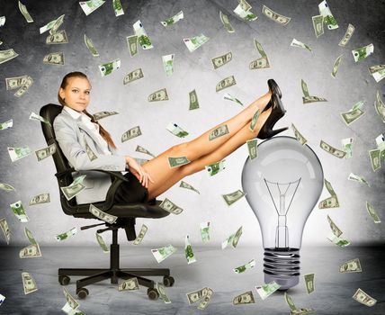 Businesswoman with light bulb and money rain, idea is money concept