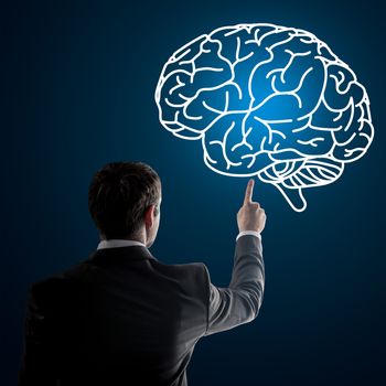 Close up of businessman pointing at brain on digital screen