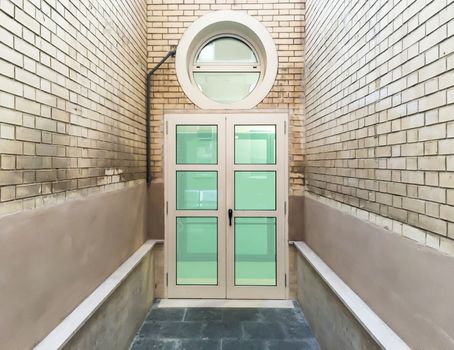 closed windows door with bricked walls