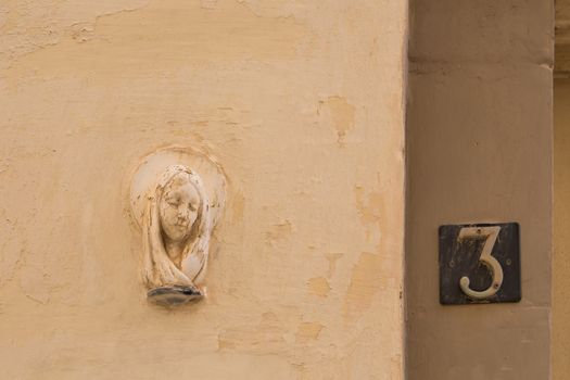 Most of the residential houses at the mediterranean island Malta have on the walls close to the entrance a portrait of the saint for the protection.