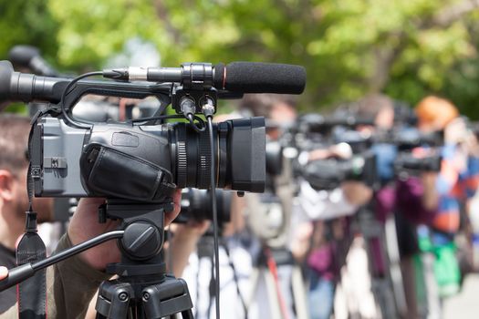 News conference. Covering an event with a video camera.