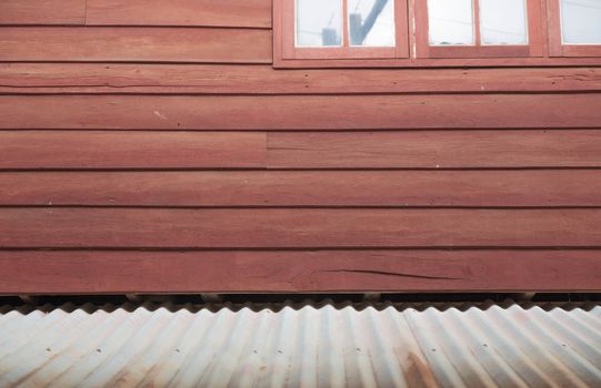 Home in rural northeastern Thailand. The upper is made of wood And the glass window Listed below are made with cement and a zinc-covered roof.