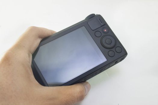hand on Compact digital camera black And white background