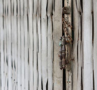 The old steel door with lock inside by iron chain.