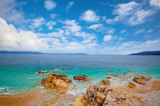 Small Adriatic coastline Croatia. Clear azure water under blue sky.