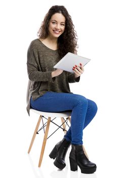 Beautiful and happy woman working with a tablet, isolated over white background 