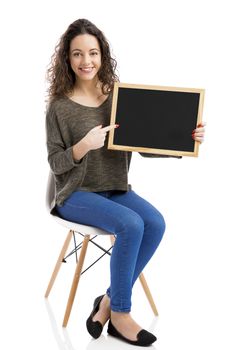 Beautiful and happy woman showing something on a chalkboard