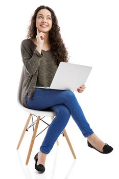 Beautiful and happy woman working with a laptop, isolated over white background 