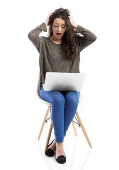 Beautiful and happy woman working with a laptop and making a panic expression