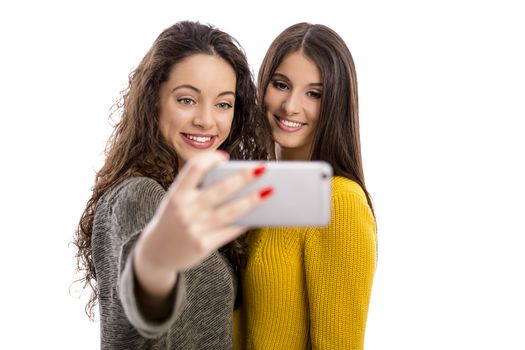 Teen girls with smartphone taking selfie