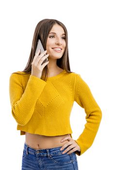 Beautiful girl making a phone call, isolated over white background