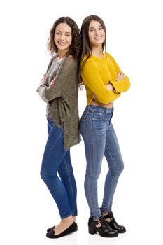 Studio portrait of two beautiful girls smiling