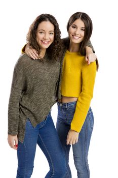 Studio portrait of two beautiful girls smiling