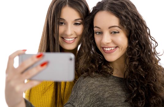 Teen girls with smartphone taking selfie