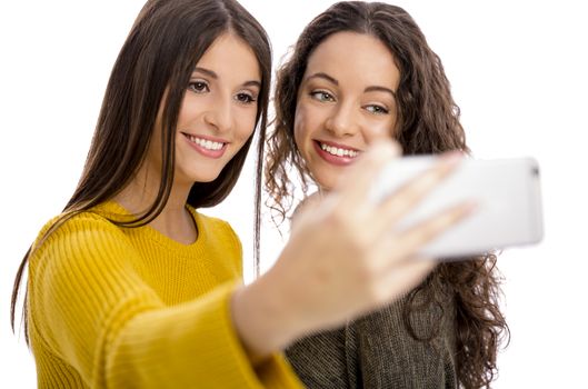 Teen girls with smartphone taking selfie