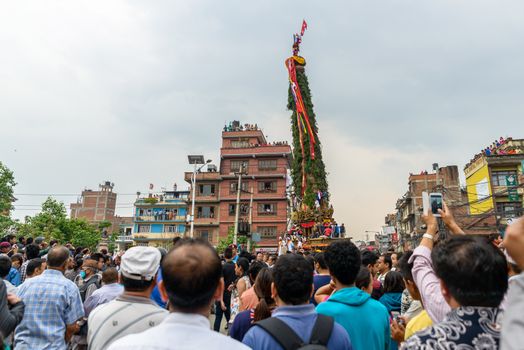 PATAN, NEPAL - MAY 10, 2016: God of Rain Rato Machhindranath chariot festival. Rato Machhindranath is worshiped as the god of rain. The chariot is pulled through the street of Patan for about a month.
