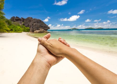 Hands together in the paradise world of Seychelles