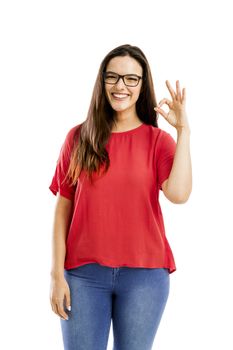 Beautiful and confident woman smiling and doing ok signal, isolated over white background 