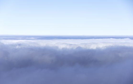blue sky and clouds on the horizon from airplane view
