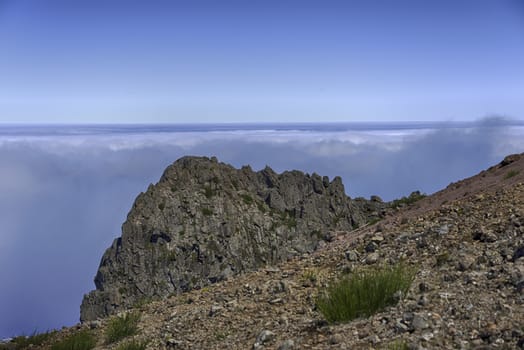 clouds above on the high mountains at madeira island called pico arieiro, the top is 1818 meters above sea level