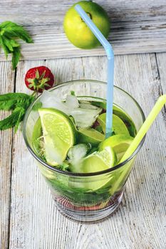 Popular summer alcoholic cocktail with rum,lime and mint.