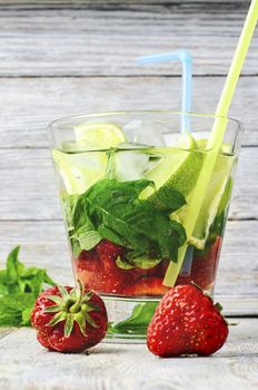 Popular summer alcoholic cocktail with rum,lime and mint.